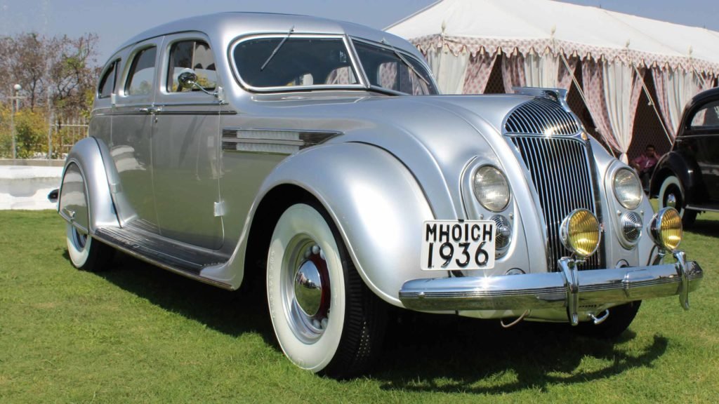 Front view of the sleek car with sloping front radiator grille and inbuilt headlights in view, Photo Credit: Karl Bhote