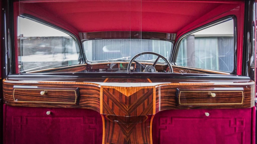 Passenger view of the rich wooden and velvet upholstered deco details inside Hispano Suiza J12; Photo Credit: https://www.artcurial.com/en/lot-1937-hispano-suiza-j12-gurney-nutting-3279-28